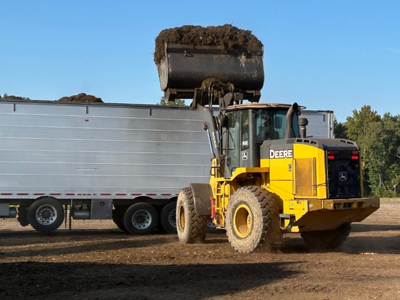 Loader loading truck for delivery